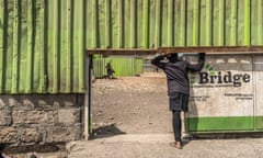 A child waits at the entrance of Bridge International Academies in the Mukuru Kwa Njenga settlement in Nairobi, Kenya.