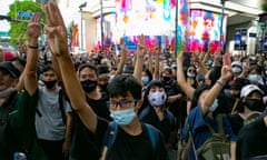 Protesters hold up the three-finger salute during a rally in Bangkok, Thailand.