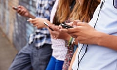 Teenagers using mobile phones.