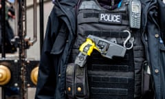 A British police officer with a Taser gun