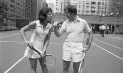 Nifty Network<br>Wimbledon champion Billie Jean King tactfully holds down the net, so that 55-year-old Bobby Riggs can easily clear it during meeting at an east side tennis club here July 11th. Returning in triumph from London, Mrs. King will meet Riggs in a $100,000 winner-take-all tennis match, it was announced July 11th.