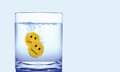 Two smiley faces fizzing in a glass of water