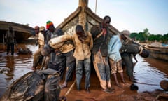 Malian workers haul out a boat they use to carry sand collected from the riverbed during a routine maintenance in the port of Bamako. 