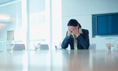 Frustrated businesswoman sitting at conference table