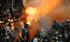 Russian soccer fans light flares during a fourth round Russia Cup match between Dinamo Moscow and Torpedo Moscow, 2012.