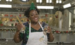 Comedian Judi Love in an apron holding her trophy