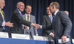 Warren Truss shakes hands with prime minister Tony Abbott at the Liberal National party state council meeting in Brisbane on 11 July 2015.