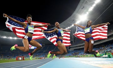 Athletics - Olympics: Day 12<br>RIO DE JANEIRO, BRAZIL - AUGUST 17:  (L-R) Bronze medalist Kristi Castlin, gold medalist Brianna Rollins and silver medalist Nia Ali of the United States celebrate with American flags after the Women's 100m Hurdles Final on Day 12 of the Rio 2016 Olympic Games at the Olympic Stadium on August 17, 2016 in Rio de Janeiro, Brazil.  (Photo by Cameron Spencer/Getty Images)