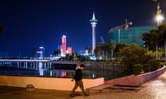 A man walks along the waterfront in Macau