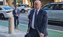 White man wearing suit and tie and carrying briefcase in street