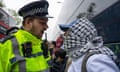 A police officer argues with protesters