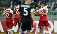 Sokratis Papastathopoulos (far right) is congratulated by his teammates after putting Arsenal ahead in Baku.