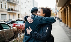 Friends hugging in the street