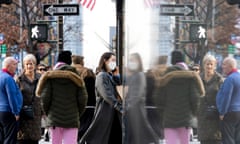 People, some wearing masks, in the Midtown area of New York City on 16 December. 