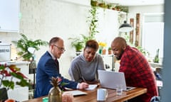 A couple listen to a financial adviser at home with a laptop