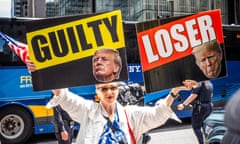 A demonstrator outside the Trump Building where Donald Trump held a press conference the morning after he was indicted with 34 counts in his "hush money” trial.
