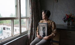Mitsuko Minakawa, 77, with her wedding
photograph; the couple moved to North Korea
in 1960
