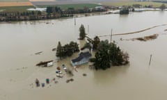 A house is completely surrounded by water in the countryside.