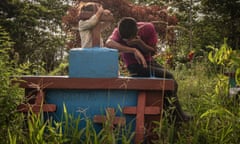 Juan Alonso crying over his father's grave