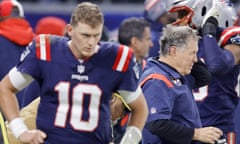 Bill Belichick looks out on to the field during the final moments of Sunday’s game as Mac Jones takes in his benching