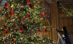 Windsor Castle Christmas Decorations. A Royal Collection Trust staff member puts the finishing touches to a 20ft Nordmann fir tree in St George’s Hall, as part of Christmas decorations being put up at Windsor Castle, Berkshire.