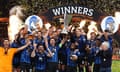 Atalanta's Berat Djimsiti and Ademola Lookman lift the trophy with teammates after winning the Europa League final against Bayer Leverkusen.