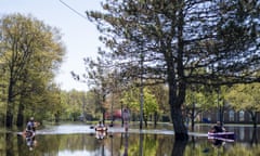 People kayak over the flooded Main Street near H. H. Dow High School in Midland on Thursday, May 21, 2020. The Edenville Dam failed on Tuesday, May 19 and caused the Tittabawassee River to flood many area throughout Midland. (Kaytie Boomer/The Bay City Times via AP)