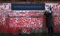 TOPSHOT-BRITAIN-HEALTH-VIRUS<br>TOPSHOT - A person writes on The National Covid Memorial Wall, dedicated to those who lost their lives to Covid-19, on the embankment on the south side of the River Thames in London on March 3, 2024, a designated National Day of Reflection. (Photo by Justin TALLIS / AFP) (Photo by JUSTIN TALLIS/AFP via Getty Images)