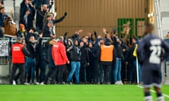 Dozens of Bordeaux fans stand on the pitch during the crushing win over Nîmes in Ligue 1.