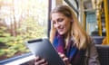 woman on train holding tablet