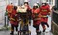 Firefighters attend to one of the victims of Friday’s attack. 