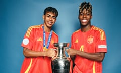 Lamine Yamal and Nico Williams pose with the trophy after Spain's win at Euro 2024