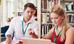 A teacher helping a student with their work.