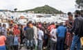 People gather at the side of an explosion in a refugee camp on the outskirts of Goma, in the Democratic Republic of the Congo