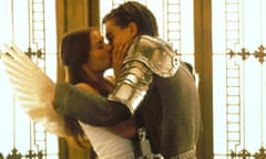 woman wearing white shirt and wings kisses man in knight's armor