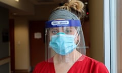 Portrait of woman nurse in red scrubs and PPE