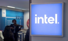 A blue and white logo reading 'intel' is displayed in an office, with people standing in the background