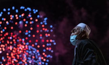 A man watches as fireworks light up the sky over Sydney Harbour