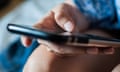 A close up of the hands of a woman using a mobile phone