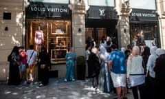 People queue outside a luxury brand Louis Vuitton store in Istanbul.