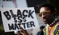Nathaniel Dyer carries a sign during a Black Lives Matter protest near Lenox Square Mall in Atlanta, Saturday, Sept. 24, 2016, in response to the police shooting deaths of Terence Crutcher in Tulsa, Okla. and Keith Lamont Scott in Charlotte, N.C. The Black Lives Matter chapter of Atlanta is boycotting major retailers following the recent police shooting deaths involving black men. (AP Photo/Branden Camp)