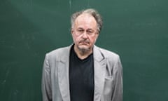Jürgen Wertheimer, who set up Project Cassandra, standing in front of a green chalkboard