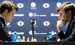 Chess players Magnus Carlsen (L) of Norway, the reigning world chess champion, and Sergey Karjakin, of Russia, contemplate their moves.