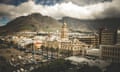 Clouds float above the Cape Town skyline and in the foreground is the city's downtown area.