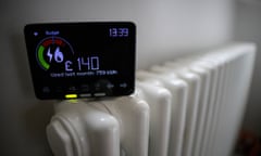 A smart energy meter, used to monitor gas and electricity use, sits on a radiator in a home in London.