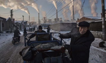 This image released by World Press Photo, titled China's Coal Addiction by photographer Kevin Frayer for Getty Images, won first prize in the Daily Life singles category and shows Chinese men pulling a tricycle in a neighbourhood next to a coal-fired power plant in Shanxi, China, on 26 November 2015. A history of heavy dependence on burning coal for energy has made China the source of nearly a third of the world's total carbon dioxide (CO2) emissions, the toxic pollutants widely cited by scientists and environmentalists as the primary cause of global warming.