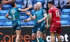 Liam Farrell celebrates scoring one of his tries for Wigan