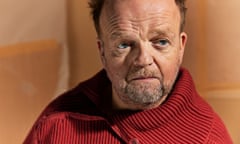 Portrait of Toby Jones in red knit jumper