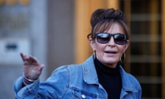 Woman wearing sunglasses and denim jacket gesturing