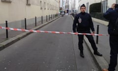 A French police officer guards a road near Charlie Hebdo’s then-offices in Paris after the 2015 terrorist attacks.